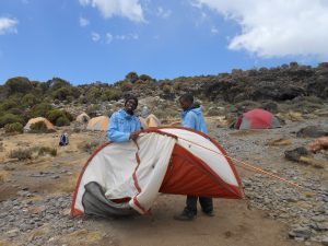 Porters putting up tents on Kilimanjaro